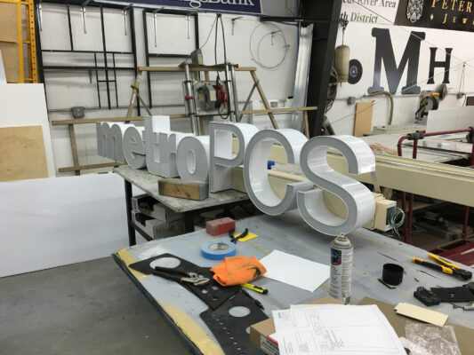 A Metro PCS Sign Being Made in Progress