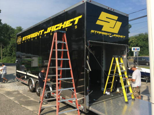 A Truck in Black With Straight Jacket Printing in Progress