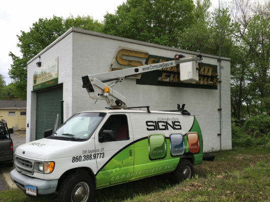 A Signboard Placed on a Facility With a Crane