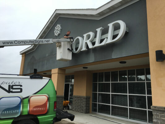 A Brand Sign Installation in Progress on a Building