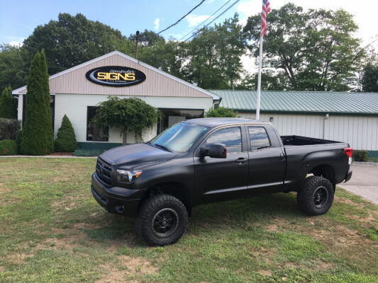 A Black Color Truck Placed Outside a Building