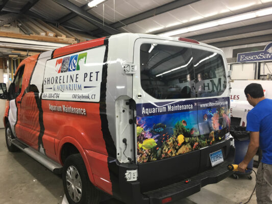 The Back of a Van With Aquarium Maintenance Printed