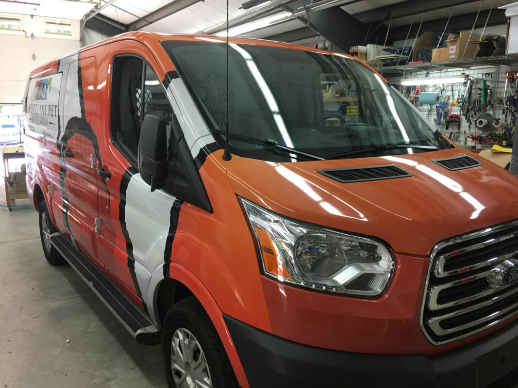 The Front of a Van in Orange and White Color
