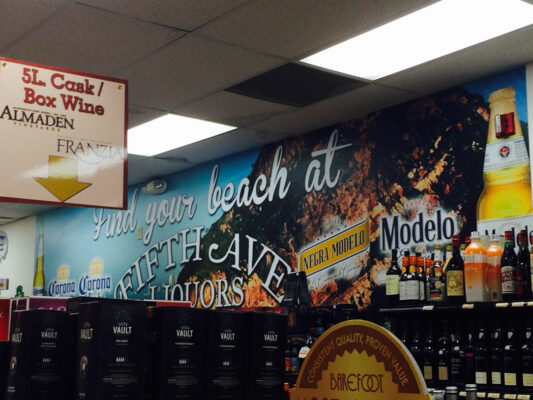 A Sign Printed on a Wine Counter of a Store With a Sign