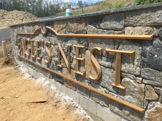 A Stone Name Board With Gold Sign