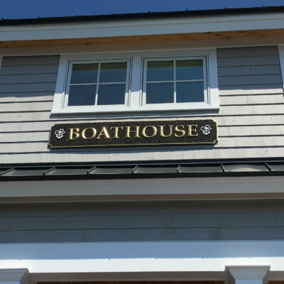 A Boat House Sign Placed on a Brown Background