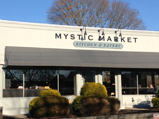 Mystic Market Kitchen and Eatery Sign on a House