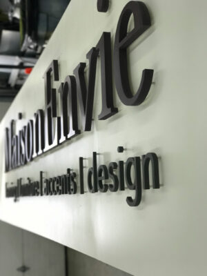 A Design Company Sign Making from Side View