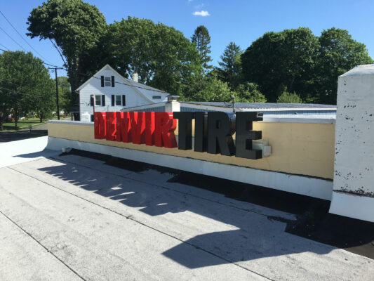 A Denvir Tire Sign in Red and Black Color