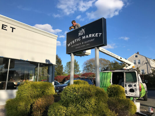 A Mystic Market Sign Set Up Outside