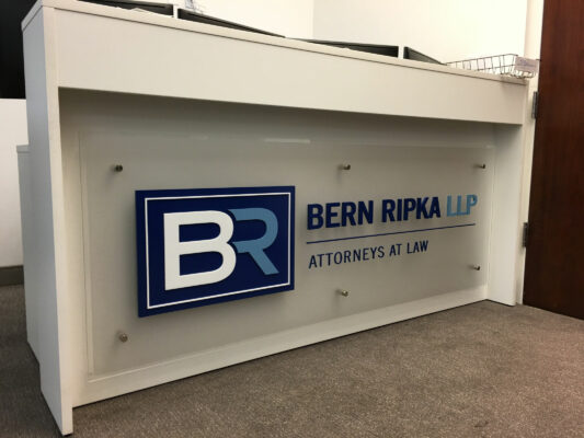 A Reception Corner With Bern Ripka Sign on Wall