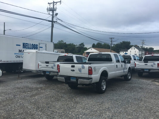 A Logo on a White Color Truck Back