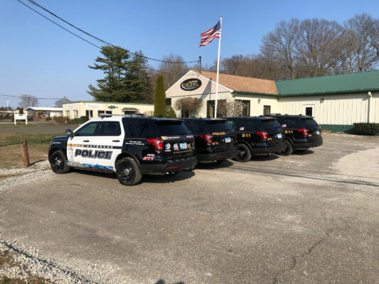 A Line of Police Vehicles in Black and White