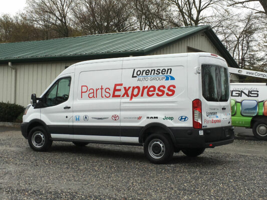 The Side of a White Van With Lorensen Auto Group Logo