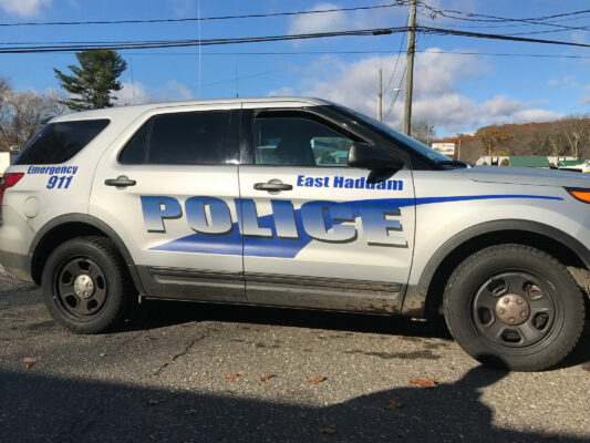 The Side of a Car in White With Police Sign