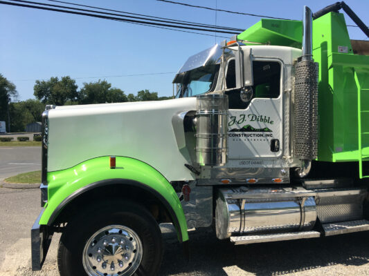 The Driver Side of a Truck in Green and White Color