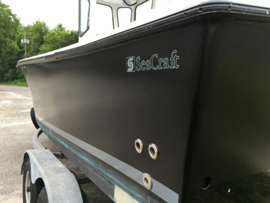 A Dark Color Hull Boat With Branding Print