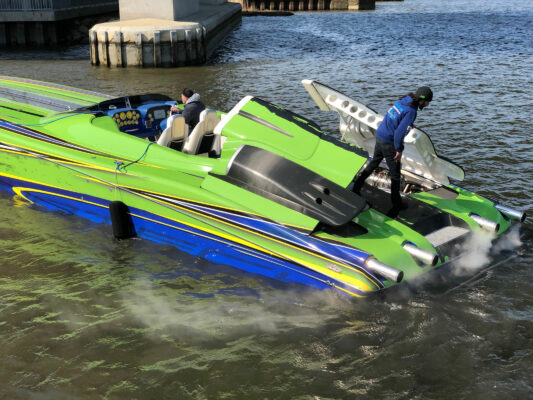 Two Men Operating a Boat in Water