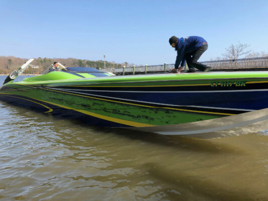 A Man Crouched Down on a Boat