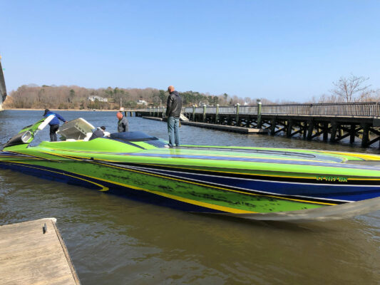 A Boat in Green and Blue Sailing