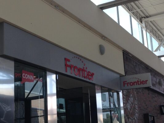 Frontier Sign in Red on a Building