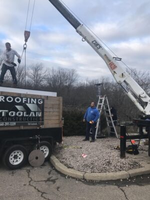 A Crane Lifting a Vehicle With Print