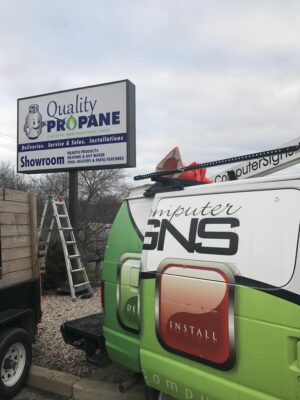 A Team Fixing Sign in of Quality Propane Board